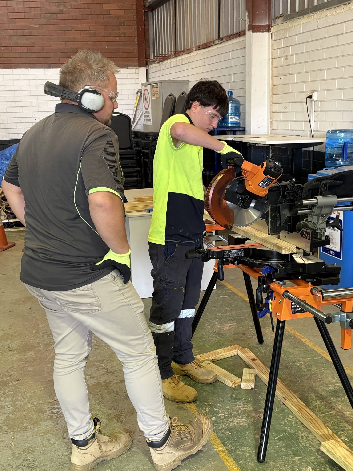 Student getting hands-on experience with a drop saw