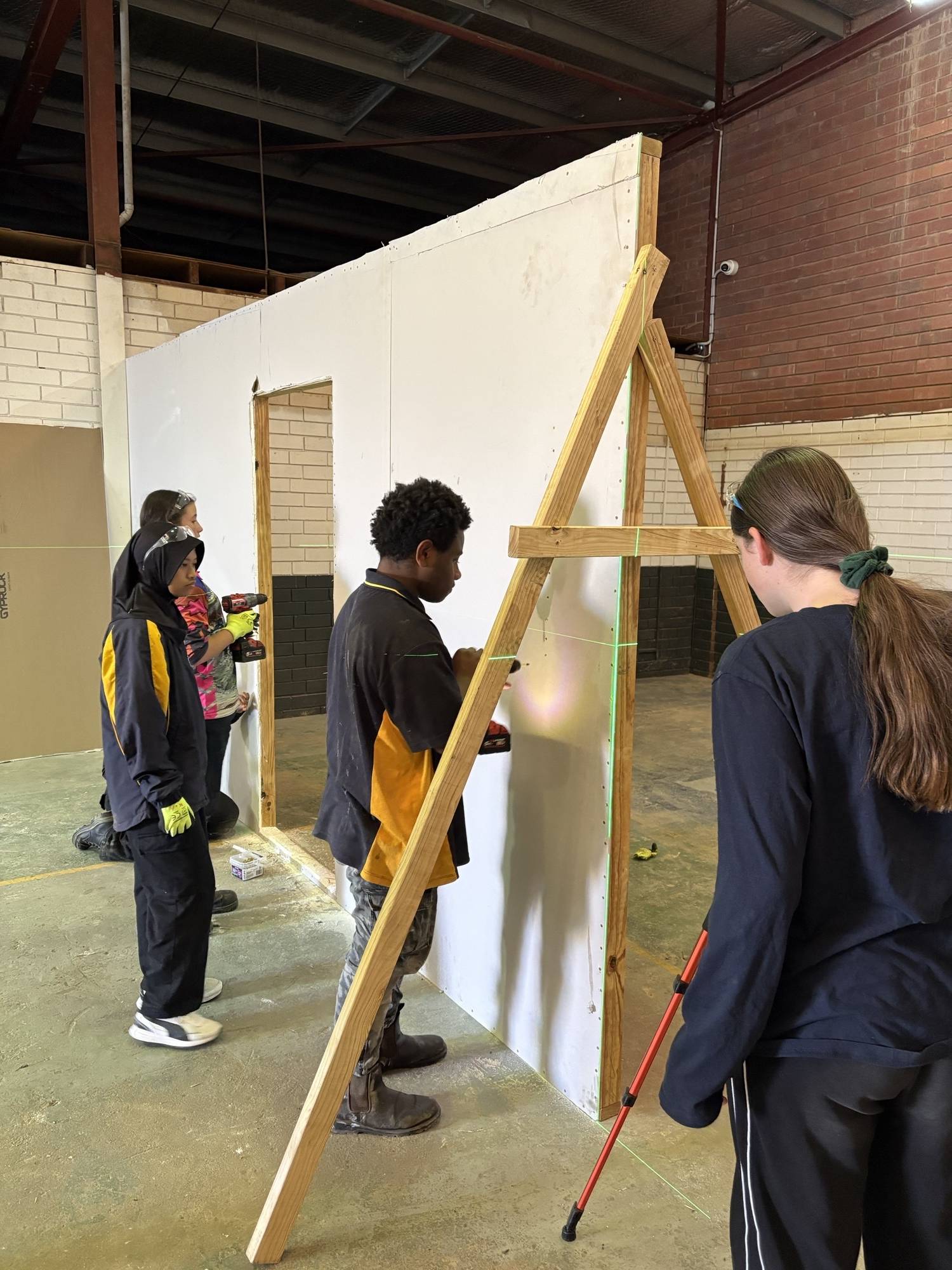 Students installing plasterboard